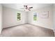 Neutral bedroom with ceiling fan, large windows, and wall decor at 3027 Griffa Ave, Columbus, IN 47203