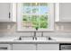Close up of the kitchen sink and the window view of the house next door at 3027 Griffa Ave, Columbus, IN 47203