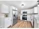 Bright kitchen with stainless steel appliances, white cabinets, and stone countertops at 3027 Griffa Ave, Columbus, IN 47203