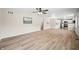 Bright open living area with views into the kitchen, freshly painted walls, and light wood floors at 3027 Griffa Ave, Columbus, IN 47203