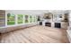 Spacious living room with stone feature wall, lots of windows, and wood flooring at 3027 Griffa Ave, Columbus, IN 47203