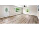 A spacious, bright living room is showcased, complete with windows and light wood flooring at 3027 Griffa Ave, Columbus, IN 47203