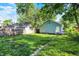 Backyard view with green grass, shed, and trees at 3109 E St Joseph St, Indianapolis, IN 46201