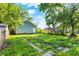 Backyard view with green grass, shed, and trees at 3109 E St Joseph St, Indianapolis, IN 46201