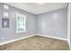 Cozy bedroom featuring carpet flooring and a window offering natural light at 3109 E St Joseph St, Indianapolis, IN 46201