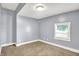 Cozy bedroom featuring carpet flooring and a window offering natural light at 3109 E St Joseph St, Indianapolis, IN 46201