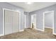 Bedroom featuring carpet flooring, a closet, and open doorway to a bathroom at 3109 E St Joseph St, Indianapolis, IN 46201