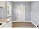View of a white back door and window located off the side of the kitchen area at 3109 E St Joseph St, Indianapolis, IN 46201