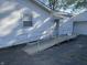 Side view of a home with a white siding and a ramp for home access at 3208 Wellington Ave, Indianapolis, IN 46226
