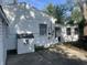 A shot of the back of the house with a white siding and a small dog house outside at 3208 Wellington Ave, Indianapolis, IN 46226