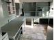 A full view of a kitchen with light blue cabinets, shelving, counters and drawers in need of repair at 3208 Wellington Ave, Indianapolis, IN 46226