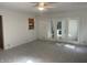 Spacious carpeted living room with glass doors leading outside at 3208 Wellington Ave, Indianapolis, IN 46226
