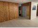 Living room with wood paneling and plank flooring at 3208 Wellington Ave, Indianapolis, IN 46226