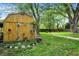 Backyard with a shed, fire pit and seating, and a lush lawn at 3552 N Talley Rd, Columbus, IN 47203