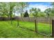 Fenced backyard with healthy green lawn and mature trees provides a secure area for recreation and outdoor enjoyment at 3552 N Talley Rd, Columbus, IN 47203
