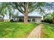 Large backyard featuring a lush lawn, mature trees, and a stone walking path at 3552 N Talley Rd, Columbus, IN 47203