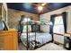 Stylish bedroom featuring a bunk bed, modern ceiling fan, and blue accent wall at 3552 N Talley Rd, Columbus, IN 47203