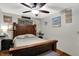 Comfortable bedroom with wood-framed bed, ceiling fan, and stylish wall decor at 3552 N Talley Rd, Columbus, IN 47203