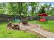 Backyard with a cozy fire pit area and charming swing sets for relaxation at 3552 N Talley Rd, Columbus, IN 47203