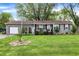 Charming ranch home with an attached garage and beautiful, green front yard at 3552 N Talley Rd, Columbus, IN 47203