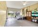 Enclosed sunroom with painted floor, ceiling fan and sliding glass doors to the backyard at 3552 N Talley Rd, Columbus, IN 47203