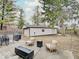 A backyard patio area featuring a fire pit, wooden chairs and an oversized two car garage at 3659 Watson Rd, Indianapolis, IN 46205