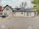 Rear exterior with stone facade, backyard parking, and outdoor entertaining area at 3659 Watson Rd, Indianapolis, IN 46205