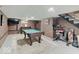 Finished basement area featuring a pool table, TV, and workout equipment at 3659 Watson Rd, Indianapolis, IN 46205