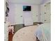 Cozy bedroom with hardwood floors, TV, and round rug with star pattern at 3659 Watson Rd, Indianapolis, IN 46205
