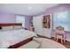 Charming bedroom with hardwood floors, soft lavender walls, wardrobe and vanity table at 3659 Watson Rd, Indianapolis, IN 46205