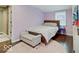 Light and airy bedroom with hardwood floors, a comfortable bed, and a pastel color scheme at 3659 Watson Rd, Indianapolis, IN 46205