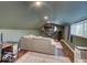 A comfortable, green walled bonus room featuring a large couch, dark hardwood floors and television at 3659 Watson Rd, Indianapolis, IN 46205