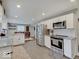 Modern kitchen with stainless steel appliances, granite countertops, and white cabinetry at 3659 Watson Rd, Indianapolis, IN 46205