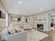 Bright living room with stone fireplace, hardwood floors and a large comfy sectional at 3659 Watson Rd, Indianapolis, IN 46205