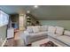 A cozy living room featuring a gray sofa, hardwood floors, and a window with natural light at 3659 Watson Rd, Indianapolis, IN 46205