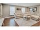 Bright and inviting living room featuring a large sectional sofa and hardwood floors at 3659 Watson Rd, Indianapolis, IN 46205