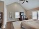A spacious main bedroom with vaulted ceiling, dark wood floors, dresser and TV at 3659 Watson Rd, Indianapolis, IN 46205
