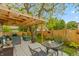 Cozy backyard deck featuring comfortable seating, a patio table, and a charming pergola at 3754 Smallwood W Ln, Indianapolis, IN 46214