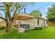 Expansive backyard with a deck, lush lawn, mature trees, and partial views of the house at 3754 Smallwood W Ln, Indianapolis, IN 46214