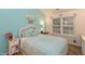 Tranquil bedroom with a wicker headboard and bright natural lighting at 3754 Smallwood W Ln, Indianapolis, IN 46214