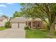 Charming single-story home featuring a brick facade, well-maintained landscaping, and a two-car garage at 3754 Smallwood W Ln, Indianapolis, IN 46214