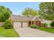 Inviting single-story home with a double garage, landscaped yard, and classic brick accents at 3754 Smallwood W Ln, Indianapolis, IN 46214