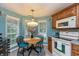 Charming breakfast nook featuring natural light, wooden table, and updated flooring at 3754 Smallwood W Ln, Indianapolis, IN 46214