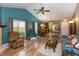 Open-concept living room with vaulted ceilings, fireplace, and access to dining area and backyard at 3754 Smallwood W Ln, Indianapolis, IN 46214