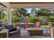 Cozy patio featuring a fire pit, seating, and a partially covered lounging area at 3904 Haverhill Dr, Indianapolis, IN 46240