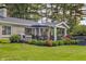 Well-maintained backyard with lush lawn, patio, and outdoor dining and lounge areas at 3904 Haverhill Dr, Indianapolis, IN 46240