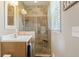 Bathroom featuring a walk-in shower with decorative tile and a wooden vanity at 3904 Haverhill Dr, Indianapolis, IN 46240
