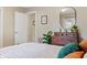 Well-lit bedroom featuring a dresser with a mirror and vibrant indoor plants at 3904 Haverhill Dr, Indianapolis, IN 46240