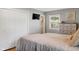 Bright bedroom featuring a cozy bed, white closet doors, and a dresser with decor at 3904 Haverhill Dr, Indianapolis, IN 46240