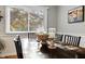 Bright dining room with wooden table and chairs, and a large window with natural light at 3904 Haverhill Dr, Indianapolis, IN 46240